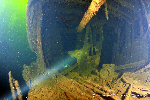 You can either exit to the left, or if you dare, the dark and narrow corridor ahead goes to the other side inside the ship. The rusty ship may collapse at any time now...